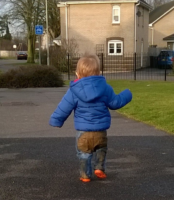 boy with mud on his bum