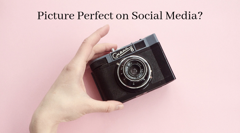 picture perfect on social media? a camera in hand on a pink background