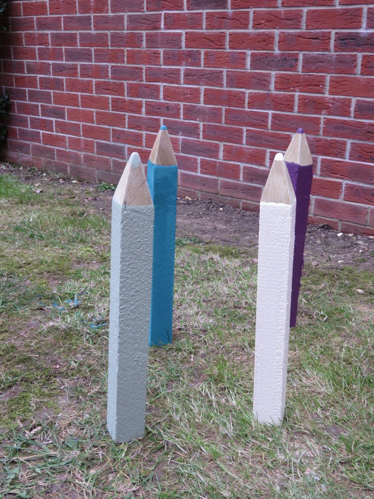 4 wooden pencils stood upright