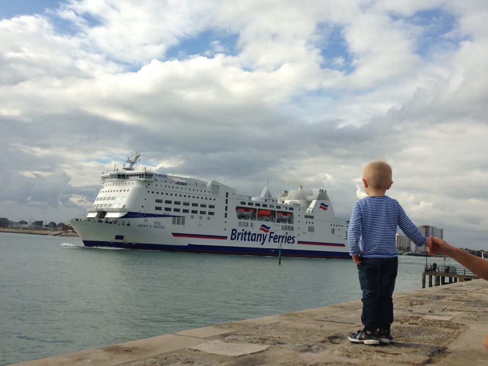 Jake watching a ferry at the sea