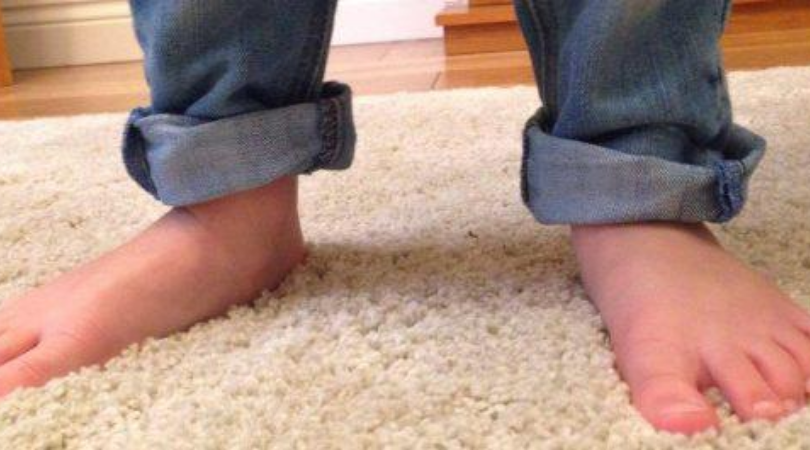 kid's jeans rolled up at his feet