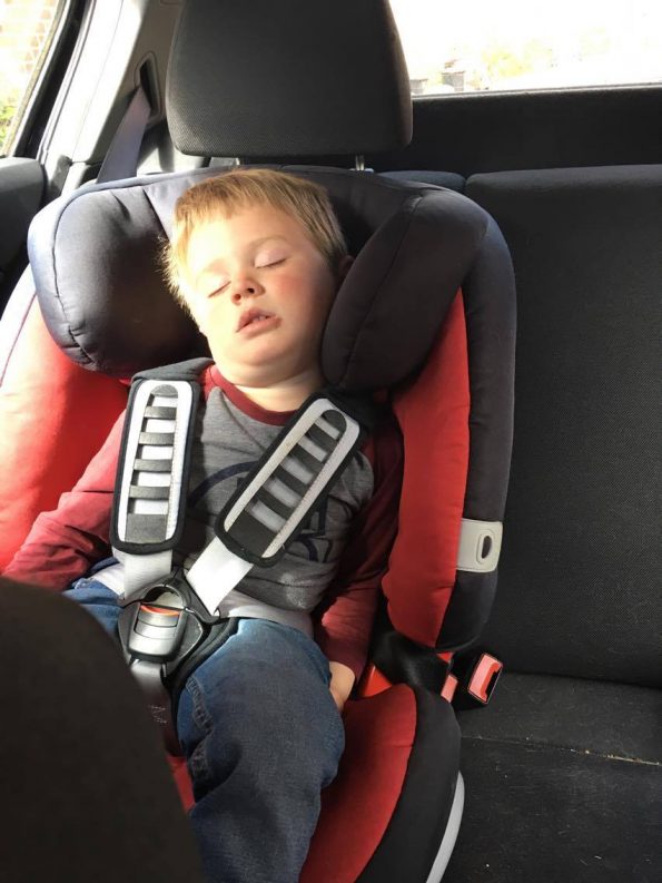 child asleep in car seat