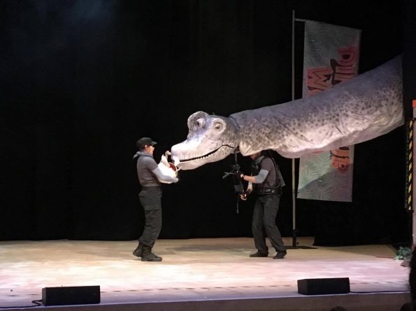 large dino head coming on the stage