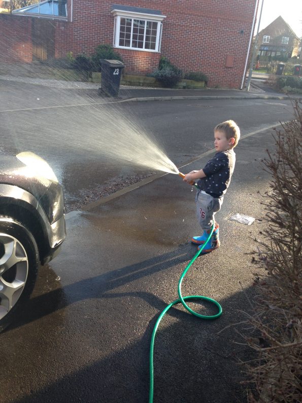 Jake washing my car with a hose