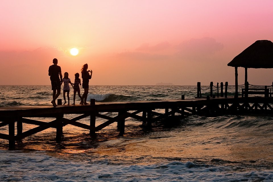 travelling with kids- a family on a pier