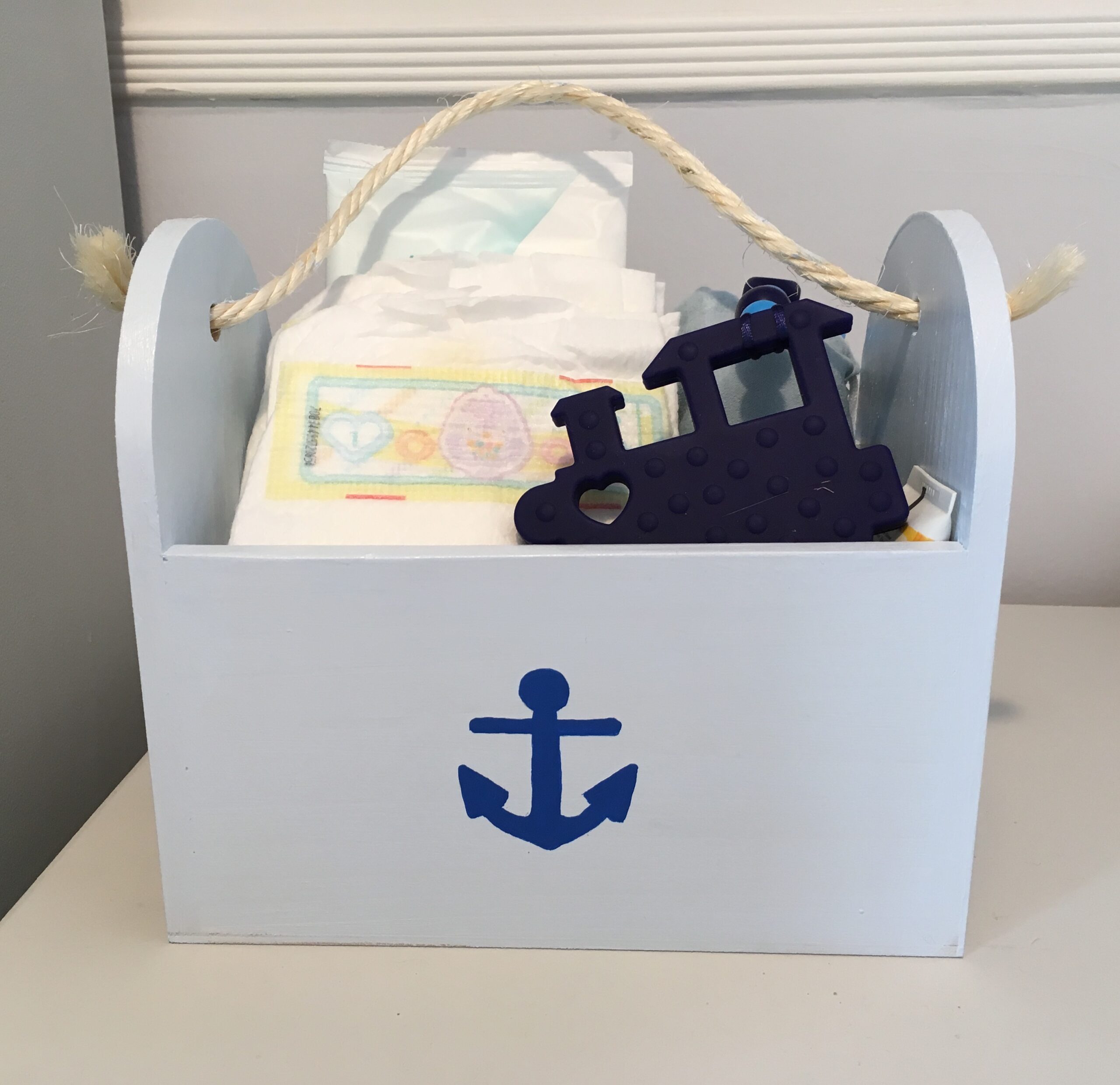 nautical themed wooden box with nappies in