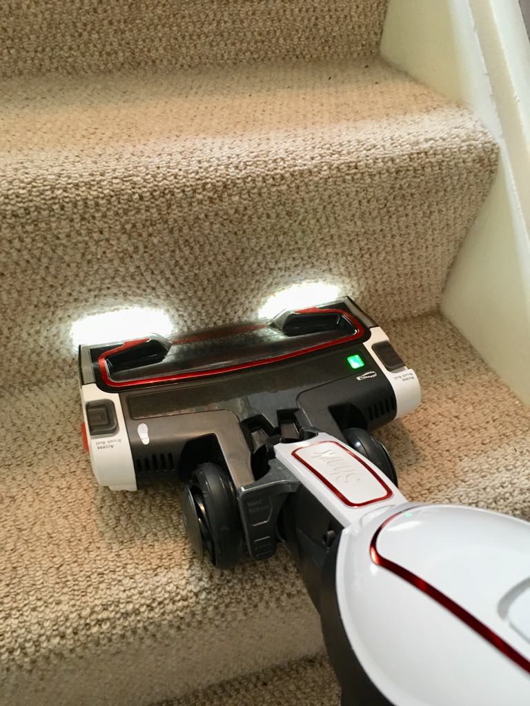 the shark with it's headlights on hoovering the stairs