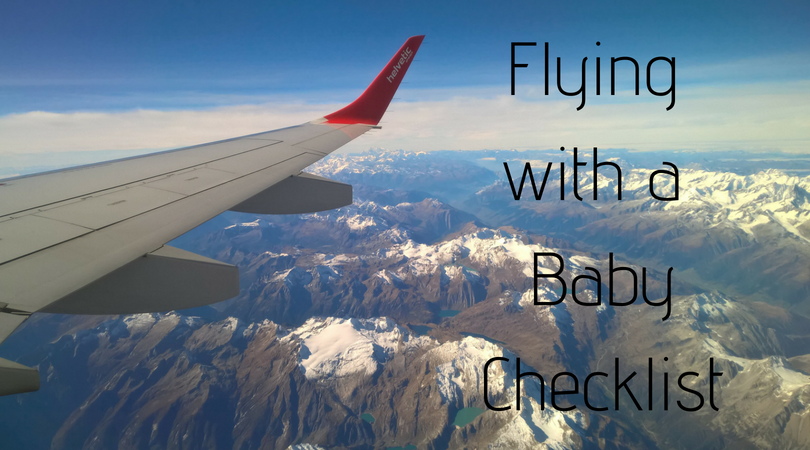 flying with a baby checklist written on a skyline with a plane