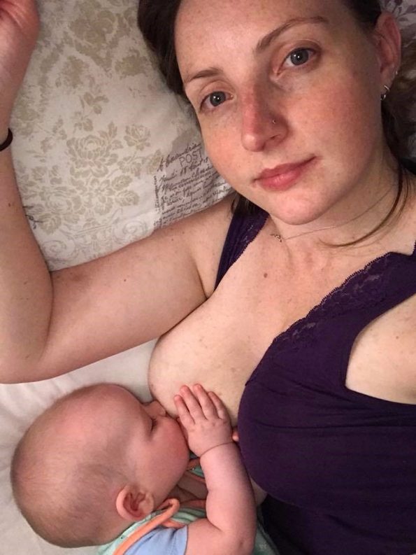 Mother breastfeeding her baby lying down