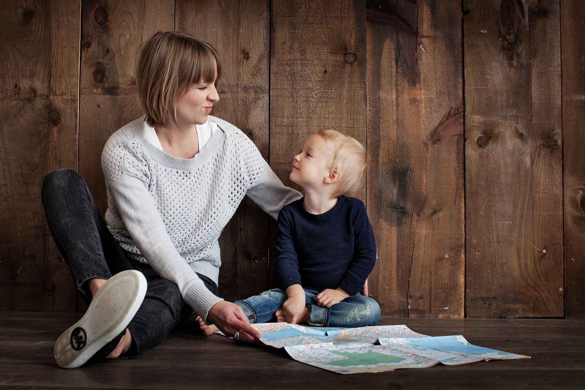 child and mother looking at a map