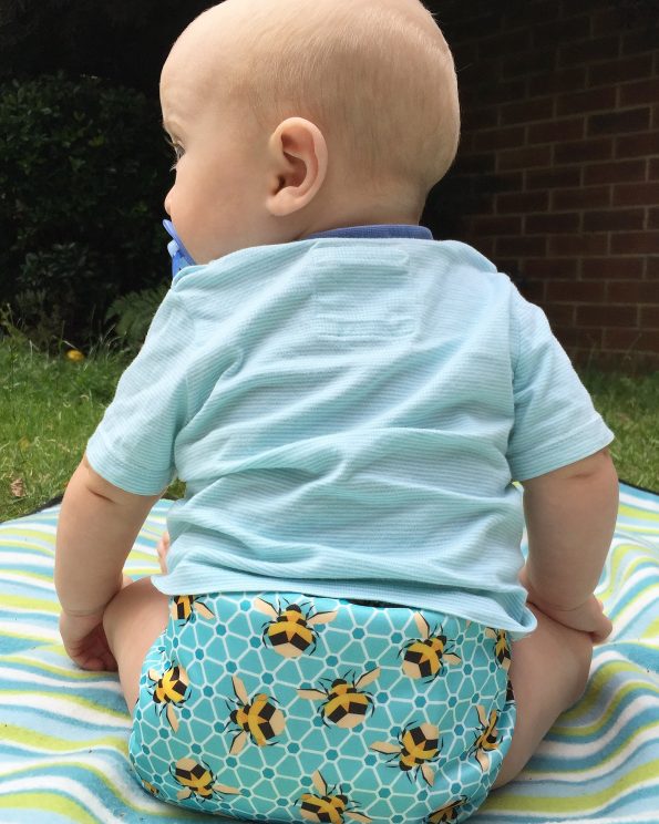 baby with his back to us wearing a bee cloth nappy
