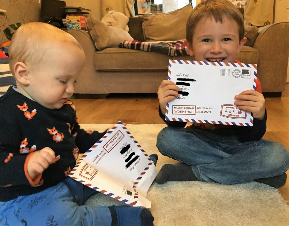 Jake holding up his letter and william holding his