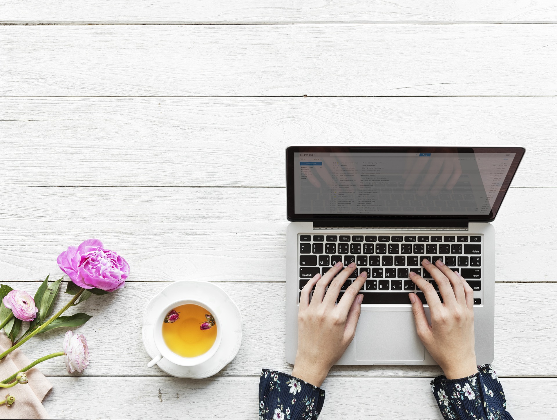 ladies hands typing emails on a computer