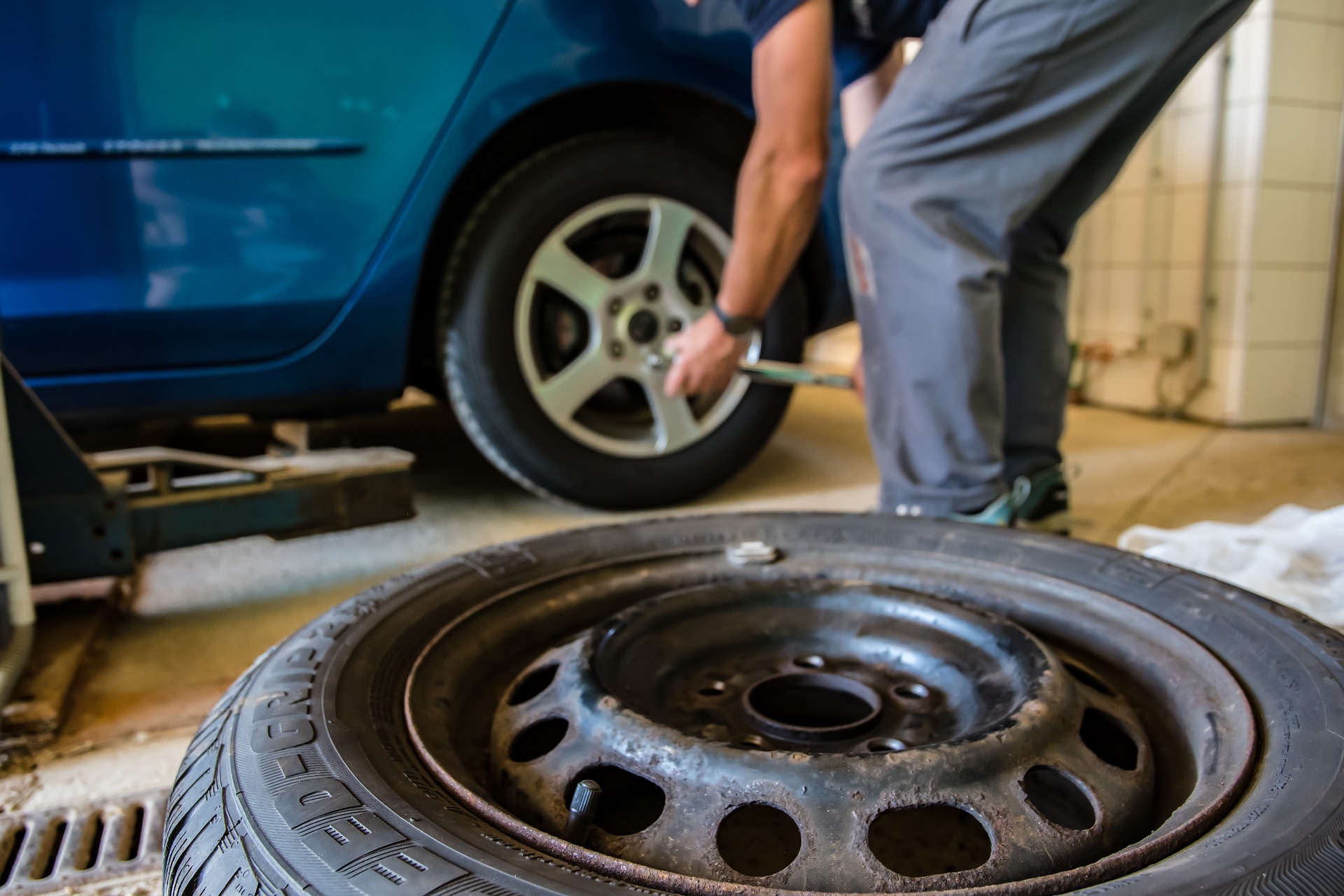 man changing tyre on car