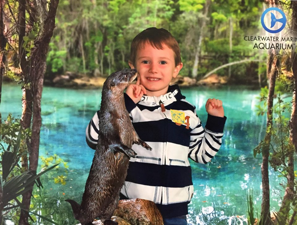 Jake's photo from clearwater marine aquarium it's an otter kissing his cheek!