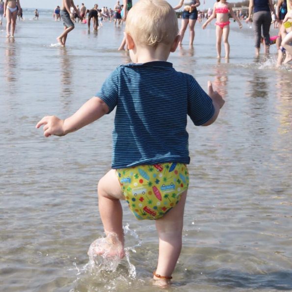 william walking through water wearing a cloth nappy