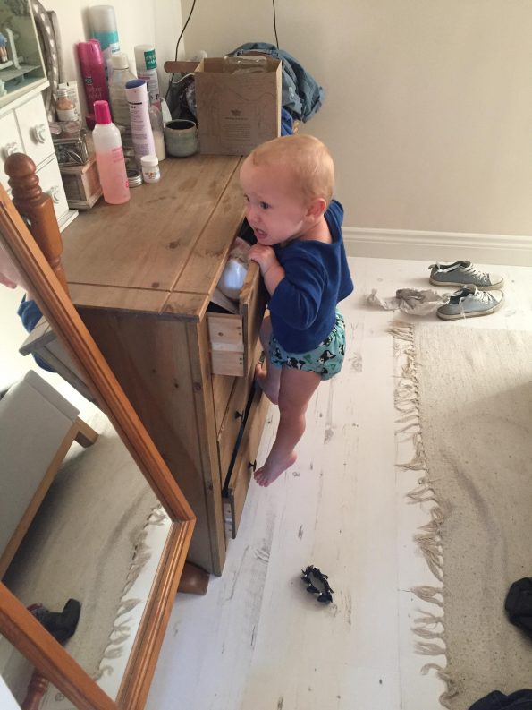 William climbing the chest of drawers