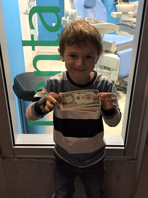 Jake holding his kidzania pounds called Kidzos