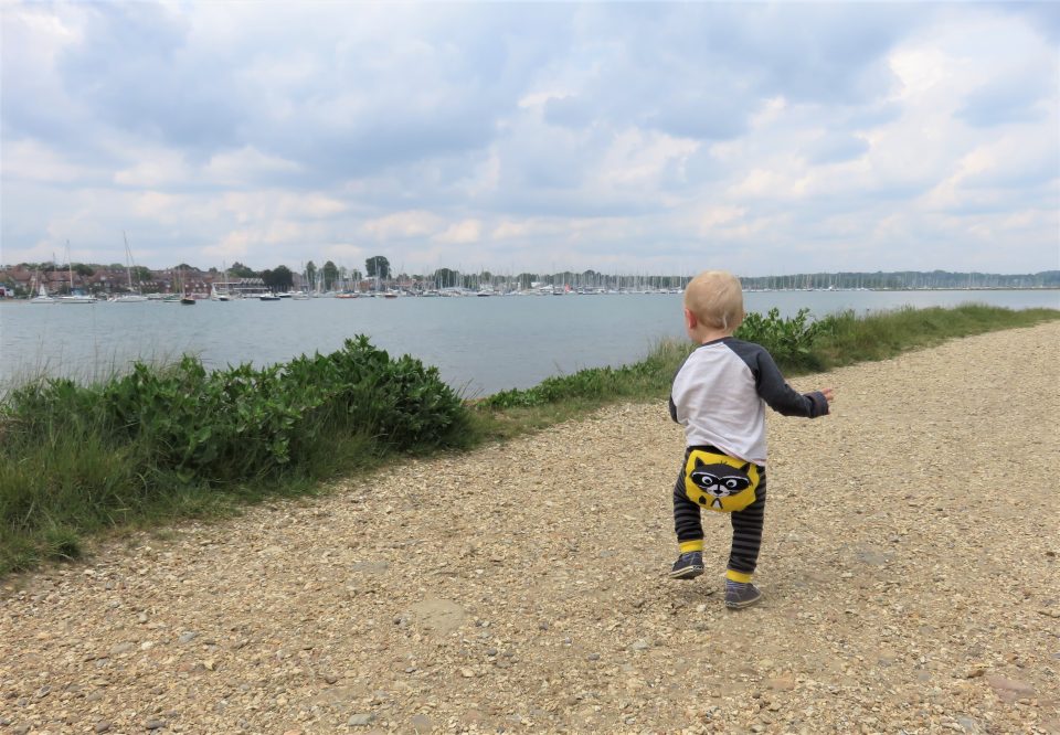 William walking on a gravel path with his back to us wearing the Ziggle raccoon leggings