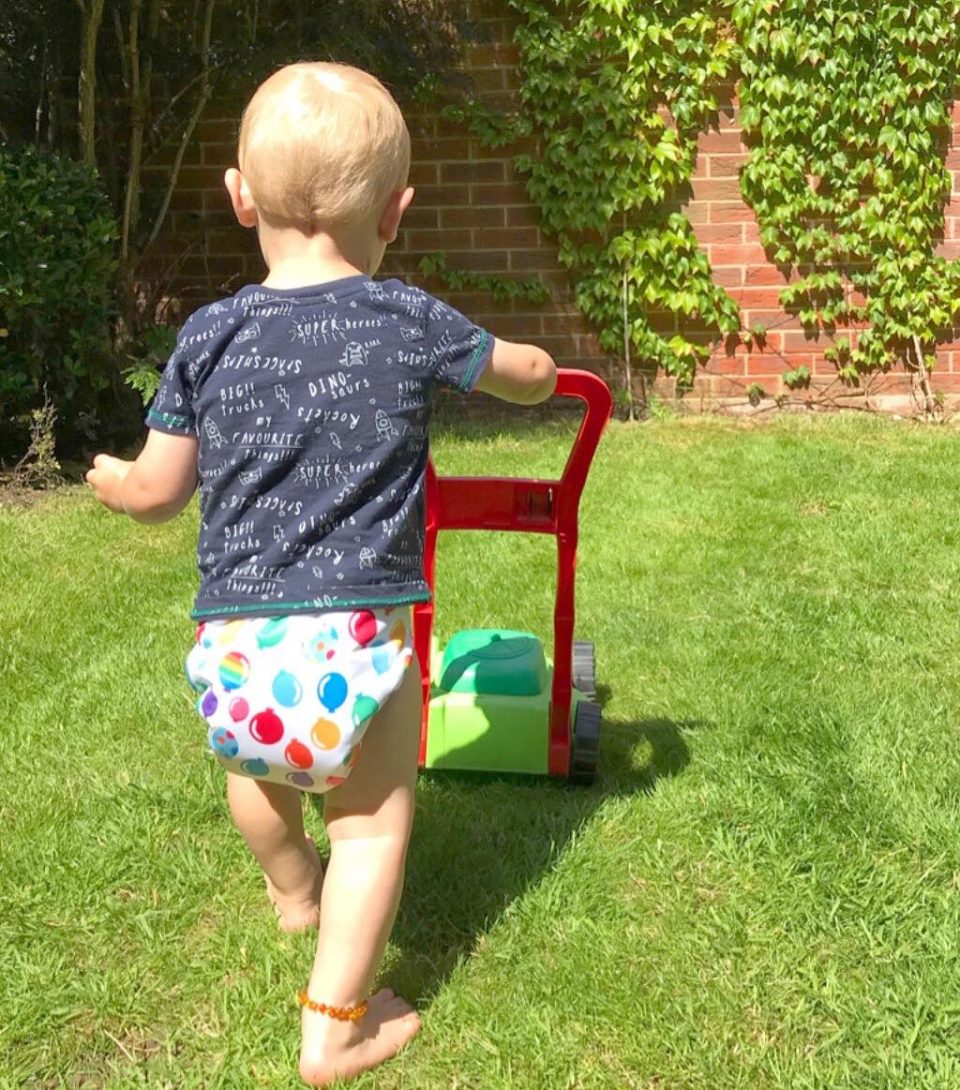 william pretending to mow the lawn in his easyfit reusable nappy