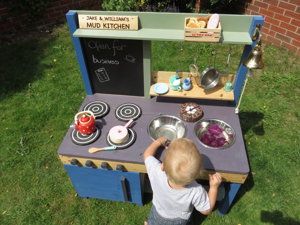 William playing with his mud kitchen