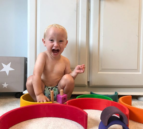 toddler sat in a cloth nappy with his mouth open like he is shouting