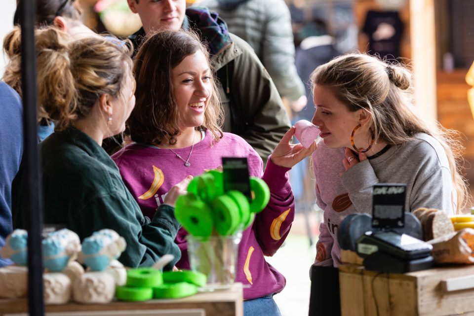 smelling bath bombs at a stall at pebble festive