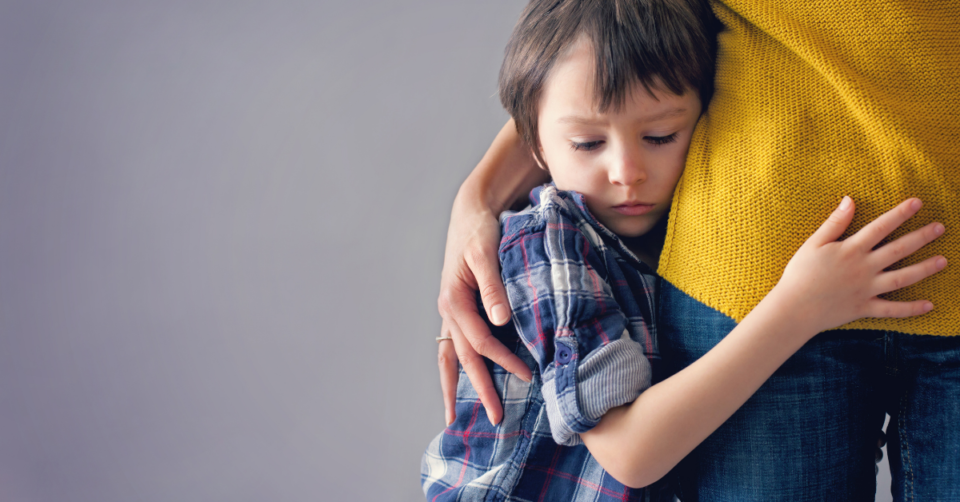 a small boy hugging a lady