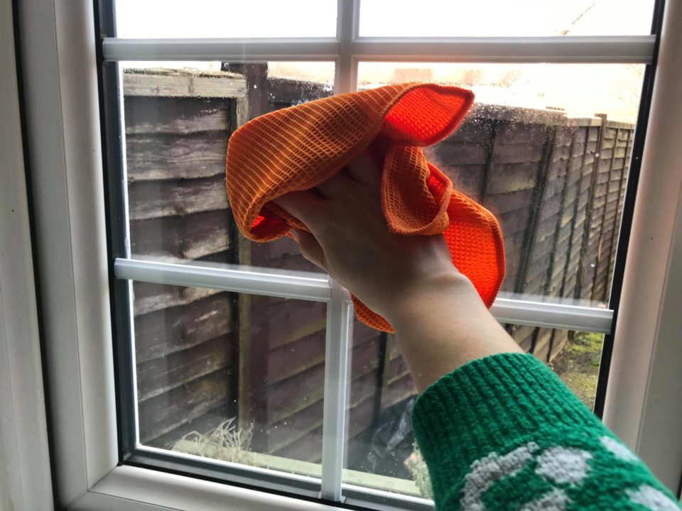 cleaning the windows with the orange e-cloth