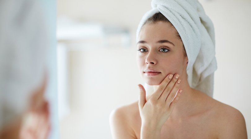 lady with a towel on her head touching her face