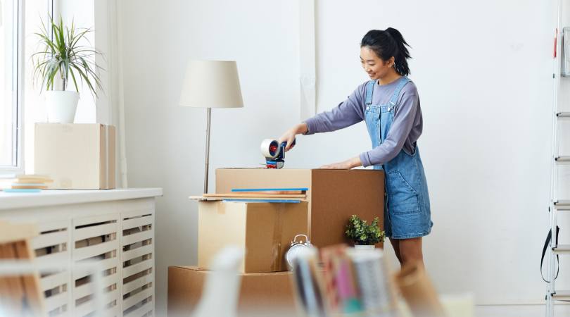 a lady packaging up some boxes to declutter