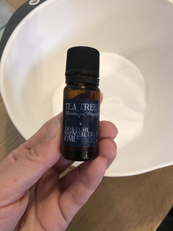 adding the tea tree oil into the mixture to make natural toilet bombs