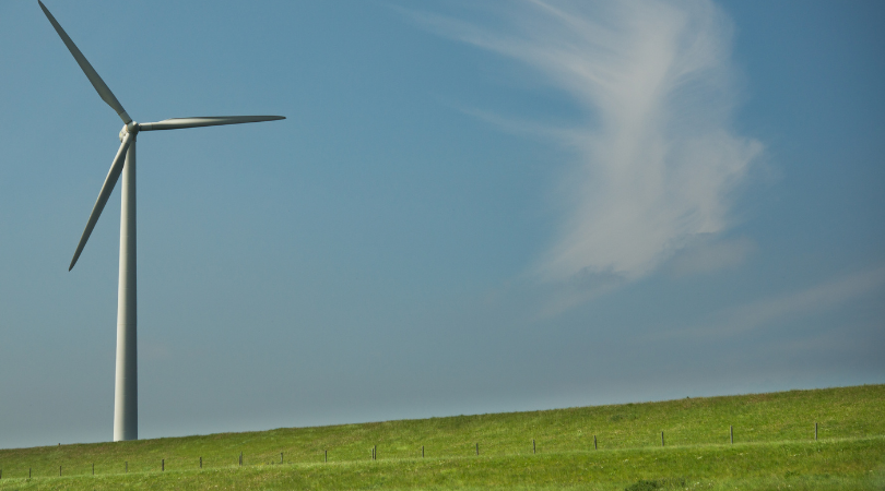 wind farm on a green hill 