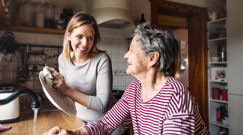 2 ladies- a grandmother and younger lady doing dishes