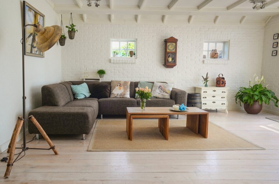 a living room with a brown sofa, rug and coffee table