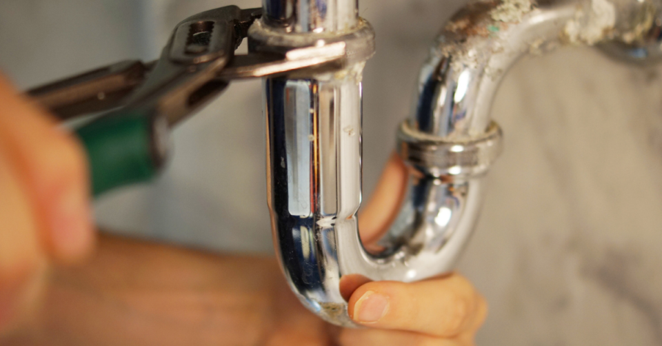 plumber fixing a pipe