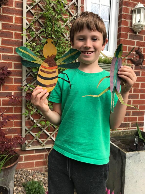 Jake holding up the finished insect projects