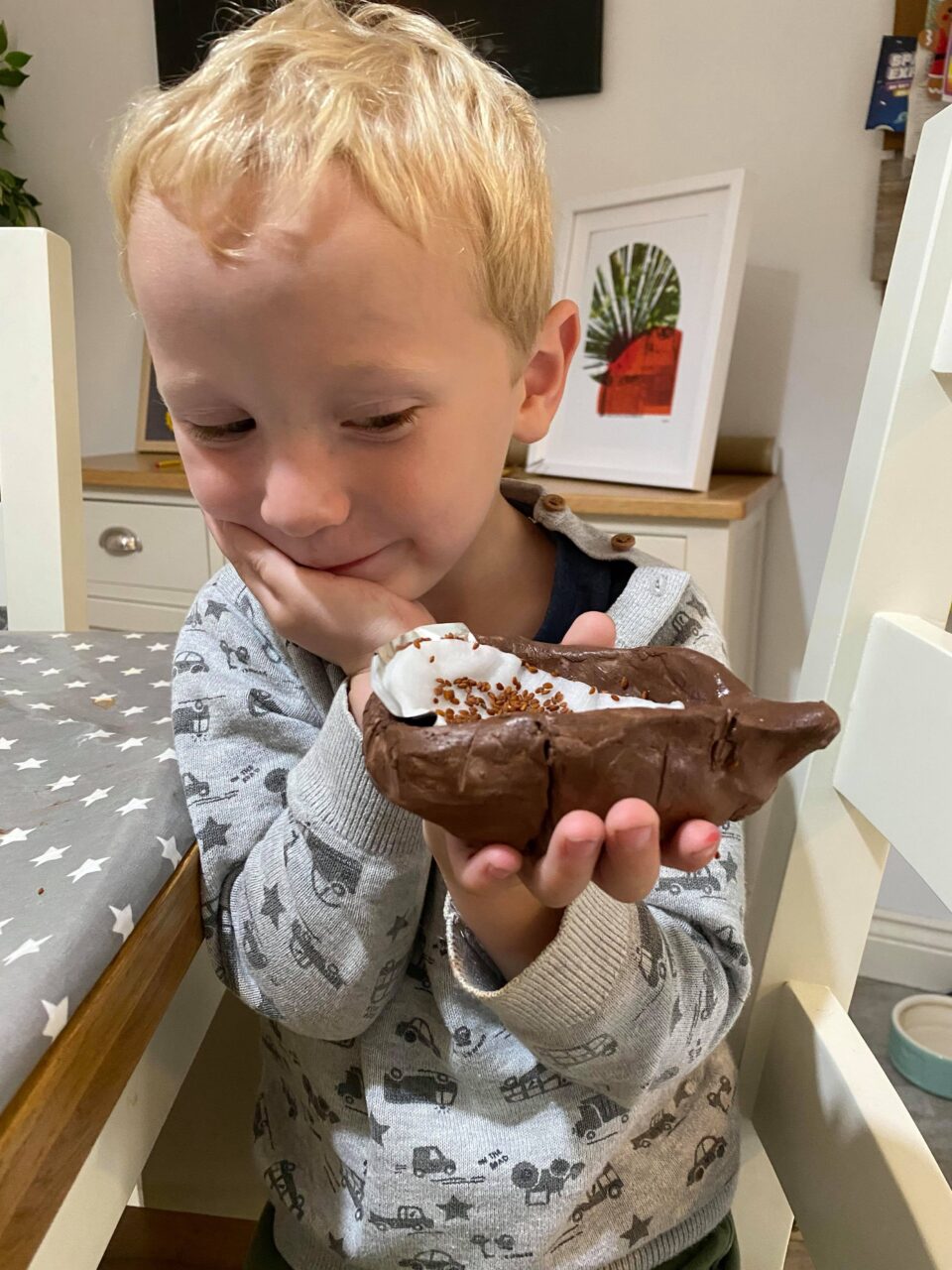 William with his finished clay hedgehog holding it up to show us