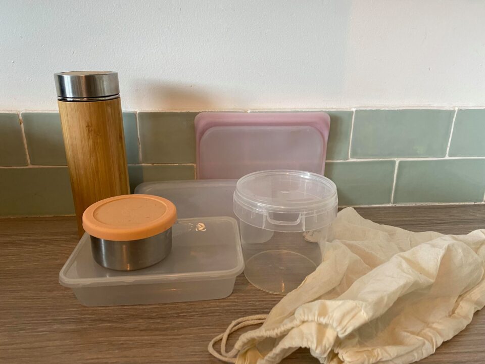 a selection of reusable pots and takeaway containers plus bag for refilling