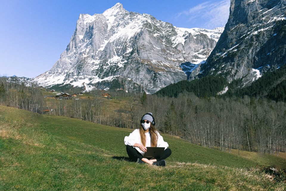 lady in the mountains wearing a mask