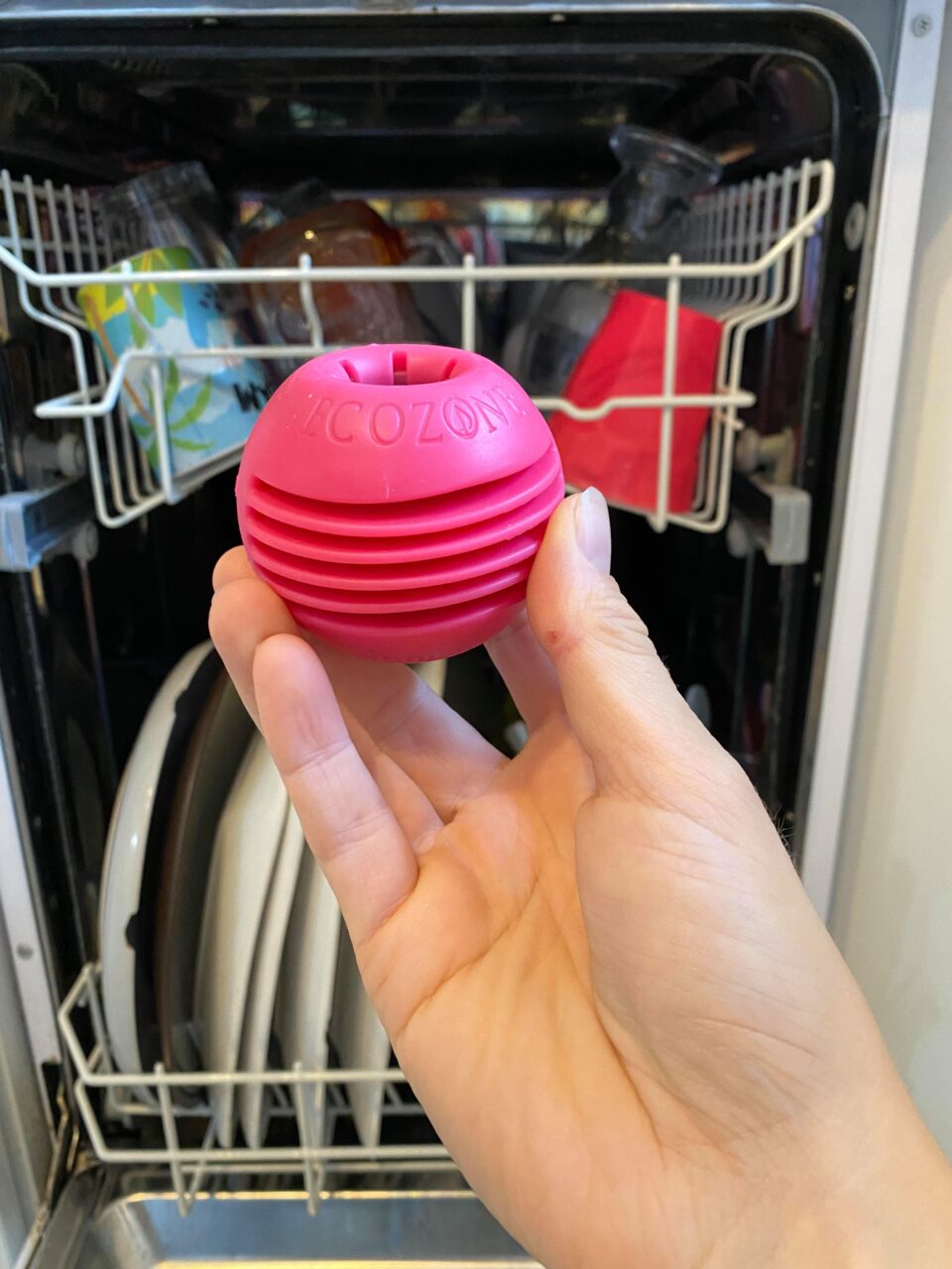 my hand holding the magnoball by the dishwasher