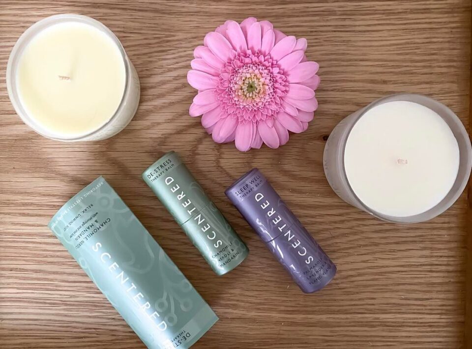 The Scentered products all laid out on an oak work top to show what I was sent for review. There is a pink flower next to them too