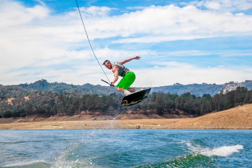 a man lifting up in the air whilst wakeboarding