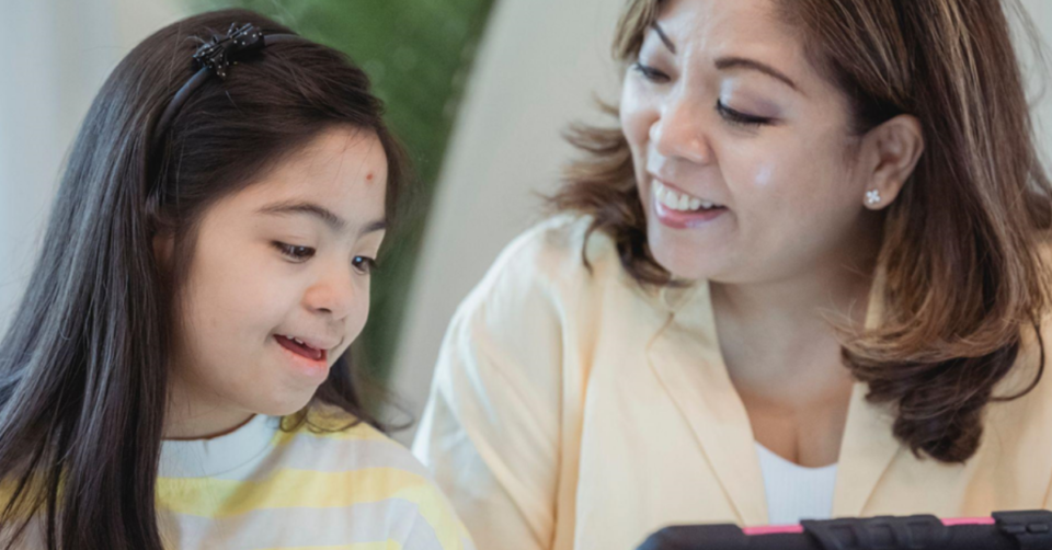 a mum and child looking at a tablet