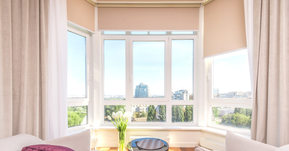 a large window with blinds and a wonderful view