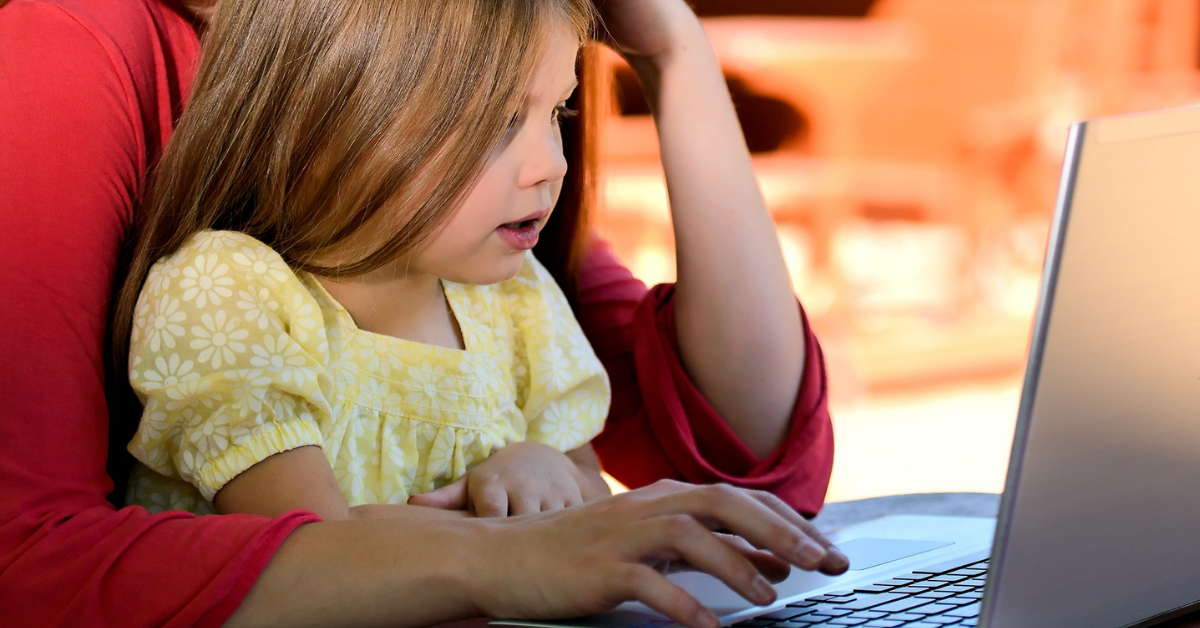 a mum and child looking at a computer