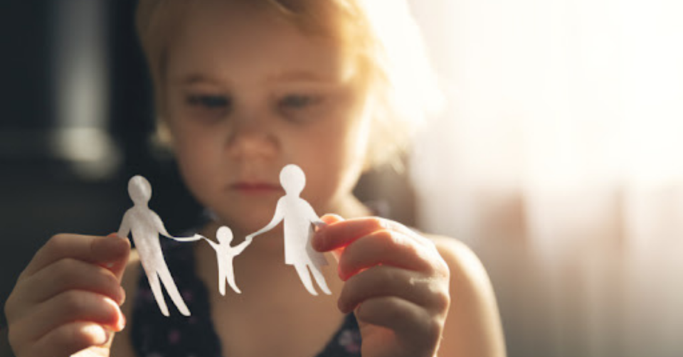 child looking at paper cut out people