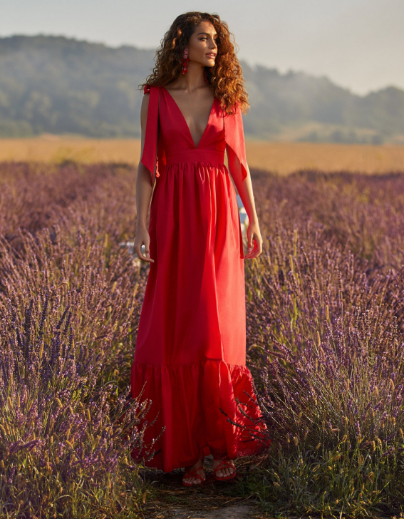 long boho red dress worn by model in a lavender field