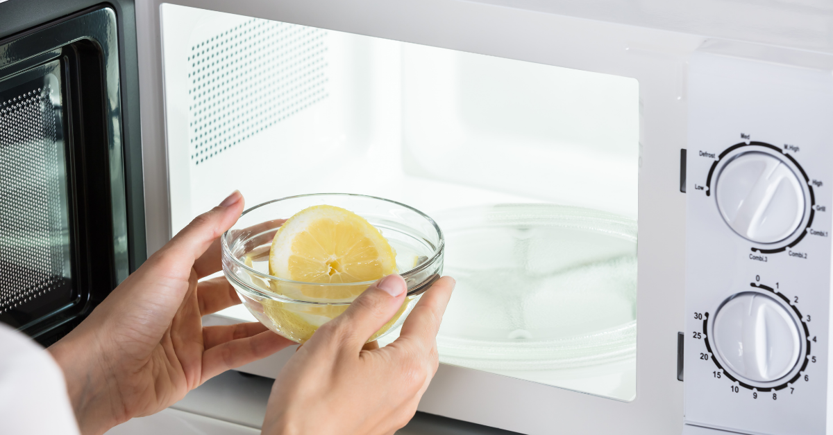 a lemon in a bowl going into a microwave