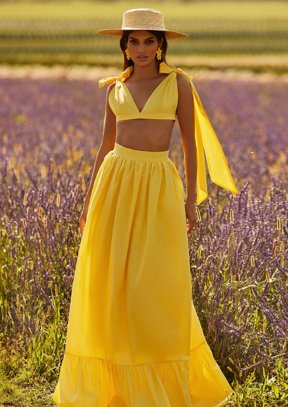 a lady in a summer outfit in a lavender field